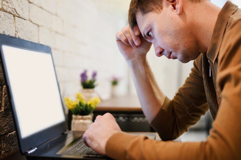 Man Works at Home on Computer and Fixing an Error