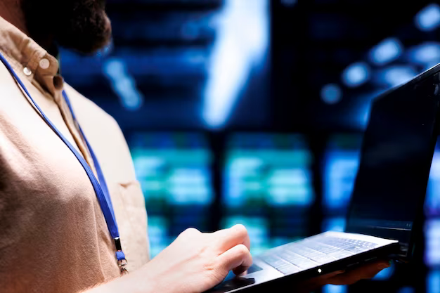 Close-up view of a man with a computer among servers