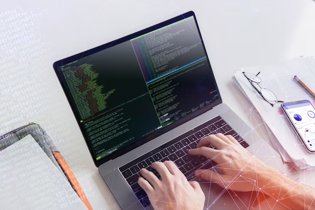 Man's hands write code on a laptop